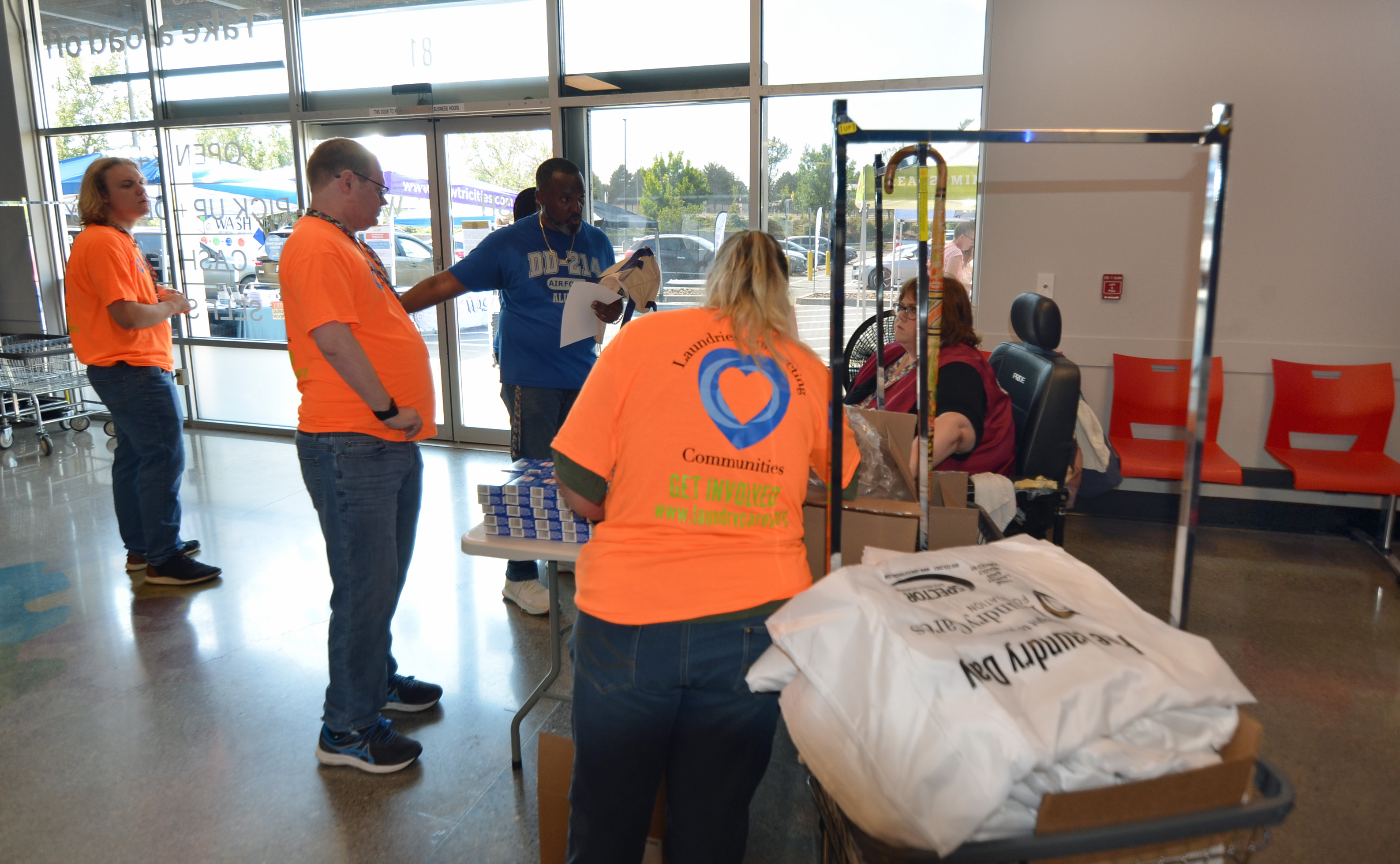 Laundry bags and visitors near The Wash entrance during Free Laundry Day